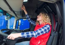 women wearing a red shirt is driving a truck