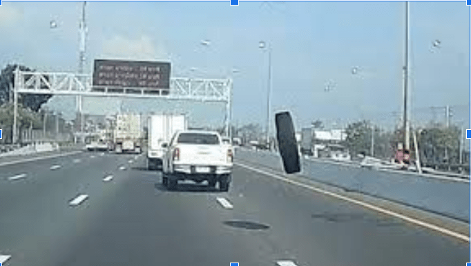 runaway tire rolling on road
