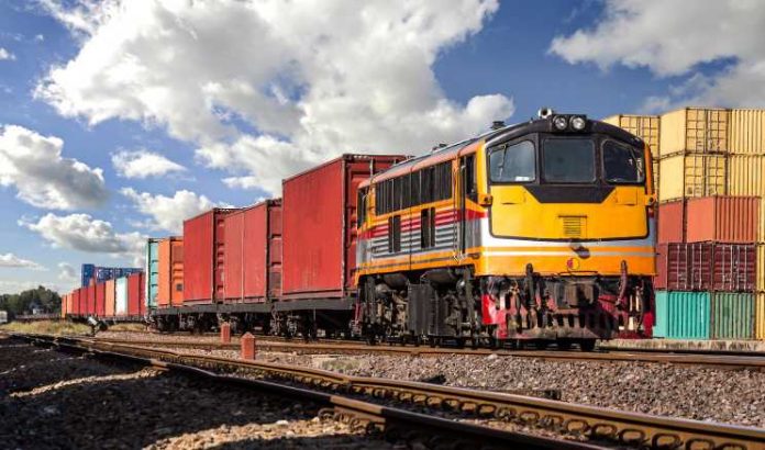 Container Freight Train with cloudy sky for intermodal port traffic