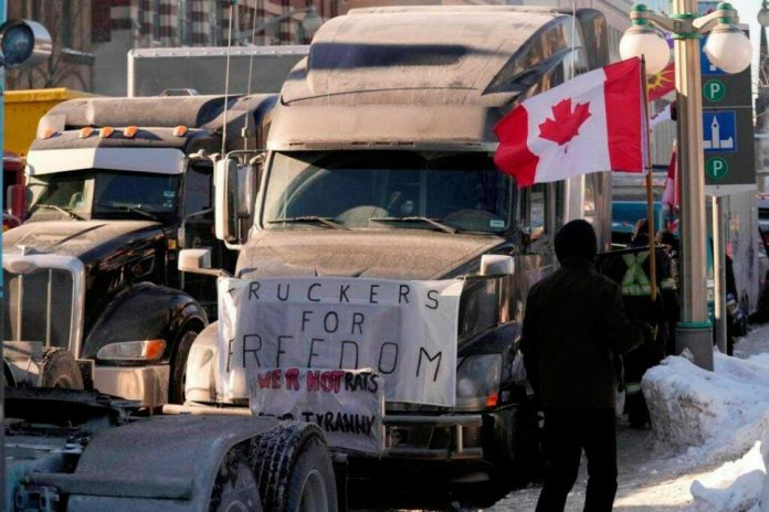 Truck at freedom convoy protesting with slogan of truckers for freedom