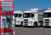 Electric vehicles charging station on a background of a trucks. Concept