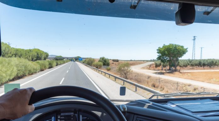 Panoramic view from inside a truck driving on a highway.