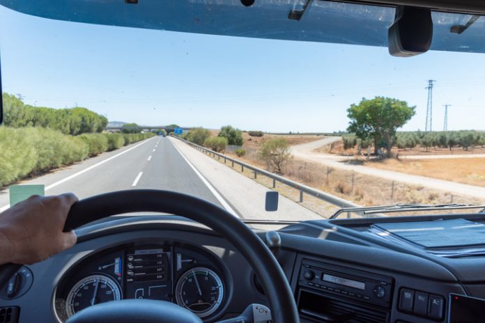 Panoramic view from inside a truck driving on a highway.