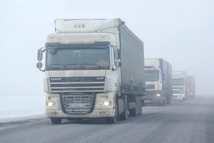 Trucks in fog driving in winter