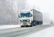 truck goes on winter road to blizzard