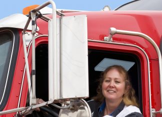 Female truck driver in a big rig.