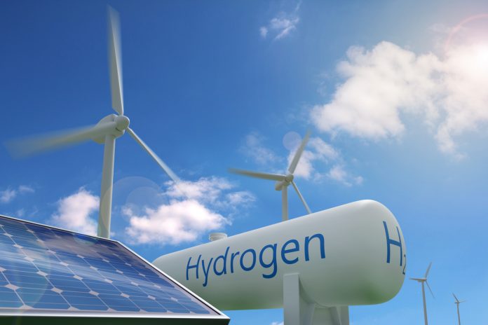 Hydrogen tank, solar panel and windmills on blue sky background. Sustainable and ecological energy concept.