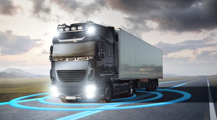 Truck with visualized sensor graphics driving on a highway
